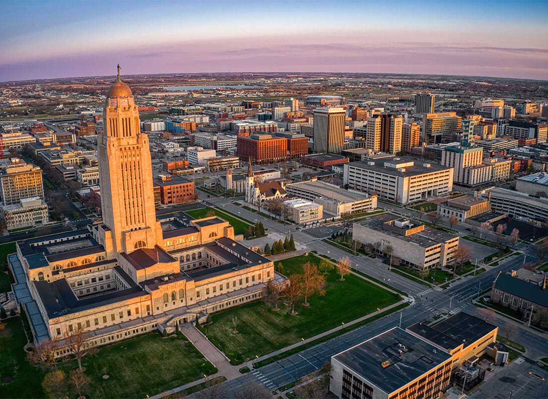Lincoln, NE - Aerial View of Buildings in Downtown Lincoln Nebraska at Sunset with a Colorful Sky